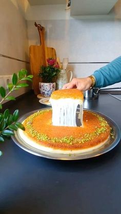 a person cutting into a cake with a knife