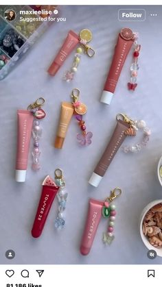 several different types of lip bales are arranged on a table with beads and charms