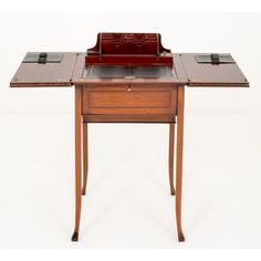 an antique desk with a leather top and drawer