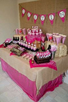 a table topped with lots of pink and brown desserts on top of a table