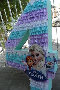 the number four is made out of paper and has an image of frozen princesses on it