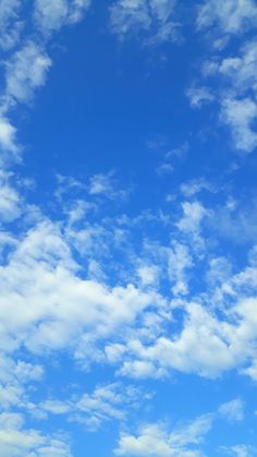 an airplane is flying high in the sky with some clouds above it and another plane on the ground below