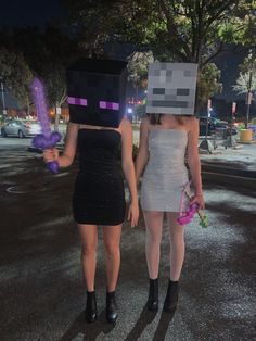 two women dressed up as minecrafts walking down the street at night with flowers in their hands