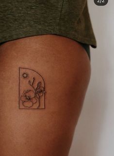 a woman's thigh with a flower tattoo on it