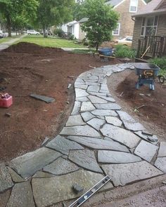 a stone path in the middle of a yard