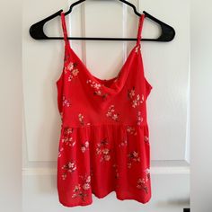 American Eagle Babydoll Tank Top Size: Xs Condition: New Without Tags, Never Worn Color: Bright Red (Almost Bright Peachy) With Floral Print Adjustable Straps Cute Red V-neck Top, Cute Red Cotton Tank Top, Casual Red Camisole For Spring, Red Floral Print Top With Spaghetti Straps, Red Floral Print Tops With Spaghetti Straps, Casual Red Top With Spaghetti Straps, Red Floral Print Spaghetti Strap Tops, Red Spaghetti Straps Top With Floral Print, Casual Red Spaghetti Strap Top