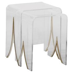 three clear acrylic tables with gold lines on the legs and one in the middle