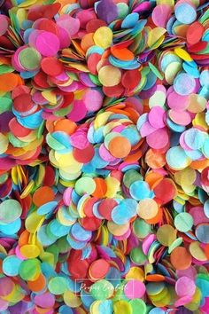 many different colored confetti pieces are scattered on top of each other in this close up photo