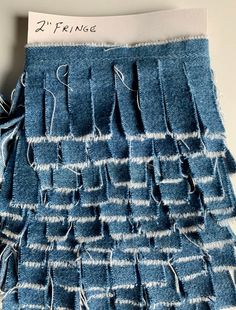 a piece of cloth with fringes on it