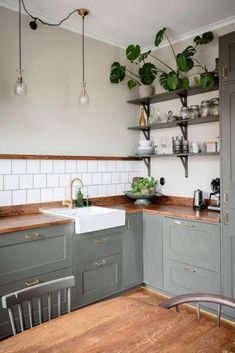 a kitchen with wooden floors and gray cabinets