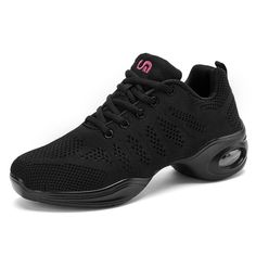 a woman's black athletic shoe with pink lettering on the upper part of the shoe