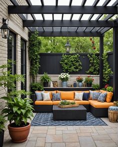 an outdoor living area with couches and potted plants