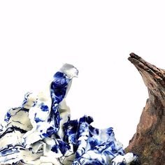 a blue and white piece of cloth sitting on top of a tree stump