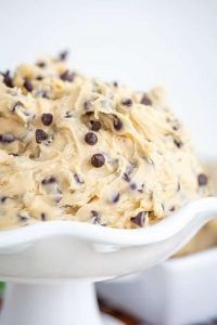 a white bowl filled with cookie dough and chocolate chips