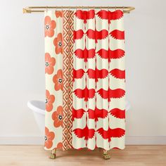 an orange and white shower curtain with red flowers in the middle on a wooden floor