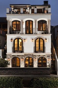 a large white building with lots of windows and balconies on the second floor