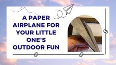 a hand holding a piece of wood with the words paper airplane for your little one's outdoor fun