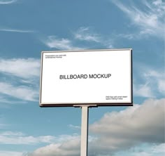 a billboard with the words billboard mockup on it in front of a cloudy blue sky