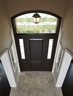 an entryway with two double doors and a light fixture