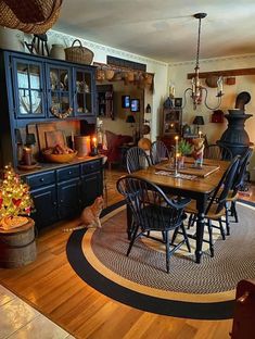 a dinning room table and chairs with candles on them in the center of a living room