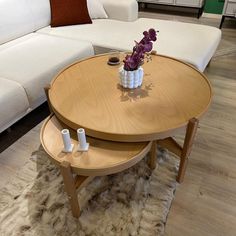 a living room filled with furniture and a white couch in front of a coffee table