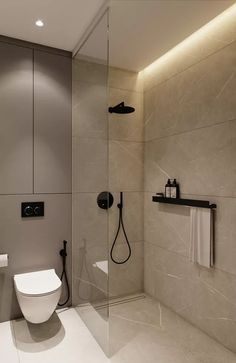 a bathroom with a toilet, sink and shower stall in it's center area