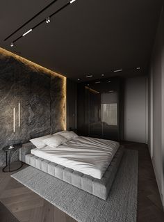 a large bed sitting in the middle of a room next to a wall with lights on it