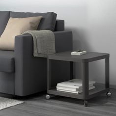 a grey couch and table with books on it