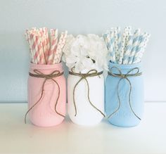 three mason jars filled with paper straws and flowers