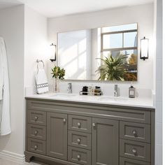 a large bathroom with two sinks and mirrors