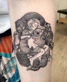 a black and white tattoo on the leg of a woman with an image of two bears