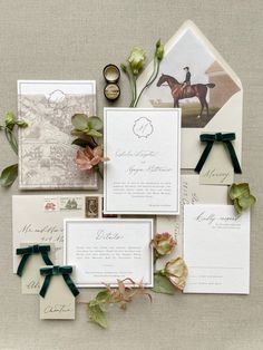 the wedding stationery is laid out on top of each other with flowers and ribbons