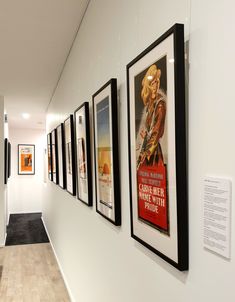 a long hallway with posters on the wall