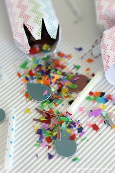 confetti cones and party favors on a table with confetti sprinkles