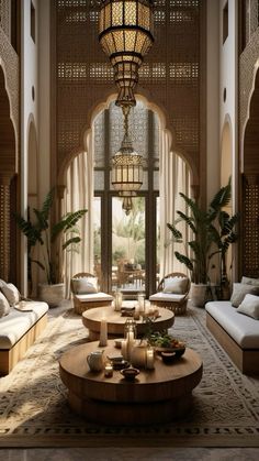 a living room filled with lots of furniture next to a tall ceiling light hanging from the ceiling