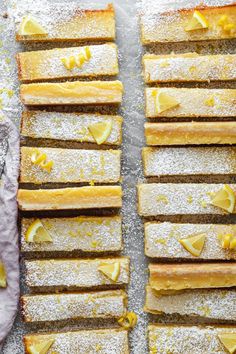 sliced lemon bars with powdered sugar on top, lined up and ready to be eaten