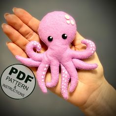 a pink octopus stuffed animal sitting on top of a person's hand with the text pattern instructions below it