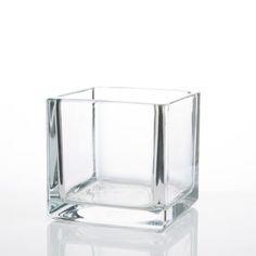 a square glass vase sitting on top of a table