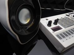 an electronic device sitting on top of a table next to a speaker and sound board