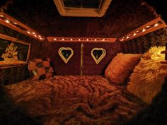 a bed with pillows and lights in a room