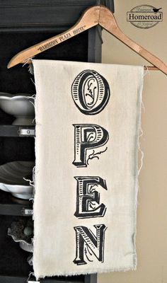 a kitchen towel with the word penn printed on it hanging from a wooden hanger