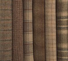 many different plaid fabrics are lined up together