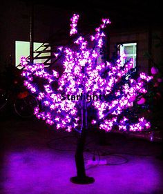 a tree with purple lights in the dark