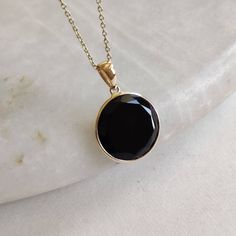 This stunning pendant is set in 14K Solid Yellow Gold with Natural Black Onyx with utmost precision. It is an unique gemstone pendant for nearly every occasion and is completely hassle-free jewelry. ITEM DETAILS * Gem: Black Onyx  * Gem Size: 15X15mm * Gem Shape: Round Flat * Gem Weight: 6.05 carats * Gold Purity: 14KT  * Gold Weight: 0.63 gram * Total Weight of the Pendant: 1.84 gram The Gold purity is guaranteed and it comes with authentic 14KT gold hallmark. Since my items are handmade, they are absolutely nickel and lead free. CUSTOMIZATION * Gemstone customization is available and it can be substituted with a gem of your choice. Kindly message me for the same. PACKAGING * The Pendant comes with layers of safe and secure wrapping along with Free handmade jewelry box with every purchase Black Necklace With Large Pendant As Gift, Black Onyx Pendant, Handmade Jewelry Box, To Buy List, Onyx Pendant, Dnd Campaign, Onyx Necklace, Bezel Pendant, Birthstone Pendant