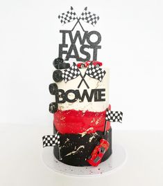 a cake decorated with racing cars and the words two east above it