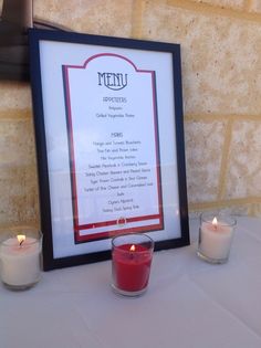 a table with candles and menu on it