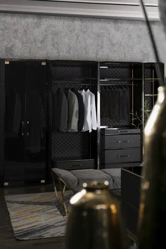 a black closet with clothes hanging on it