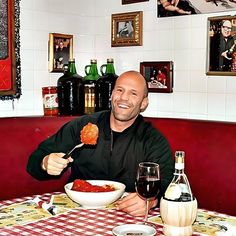 a man sitting at a table with a bowl of food