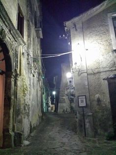 an alley way at night with the light on