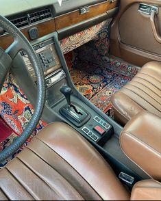 an interior view of a car with the dashboard and dash board showing, including steering wheel